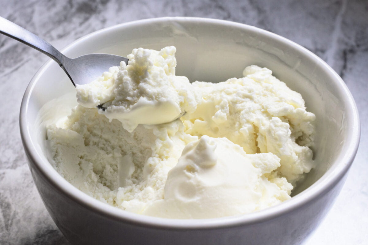 Spoonful of homemade vanilla ice cream in bowl