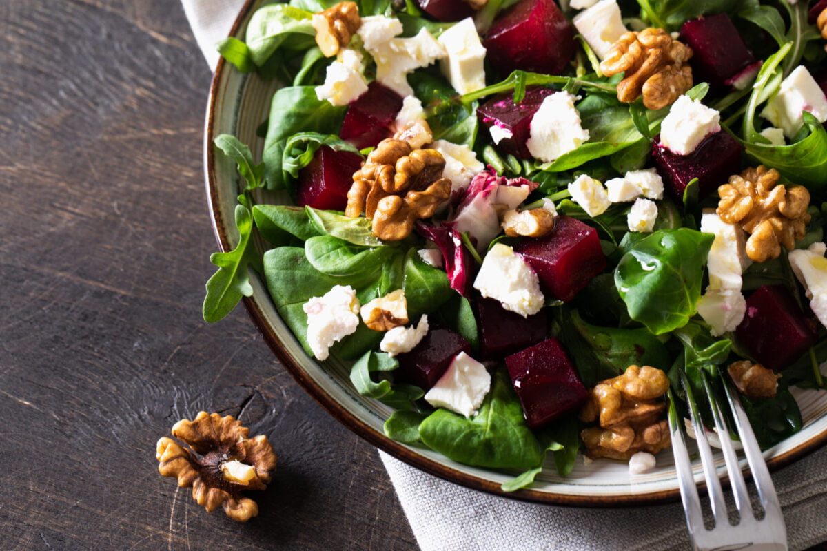 Beet and Goat Cheese salad in bowl on dark background