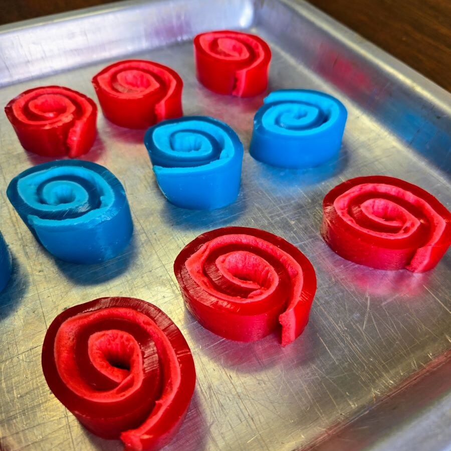 side view of silver pan of jell-o roll ups
