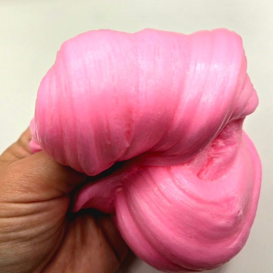 Hand holding fluffy pink slime
