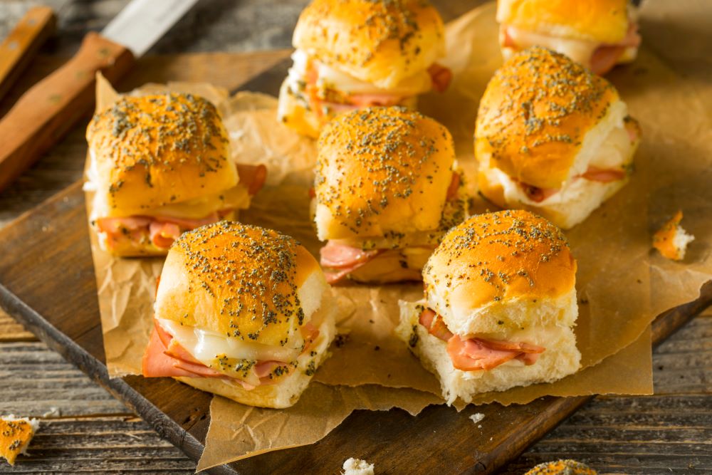 ham and cheese sliders on wooden table